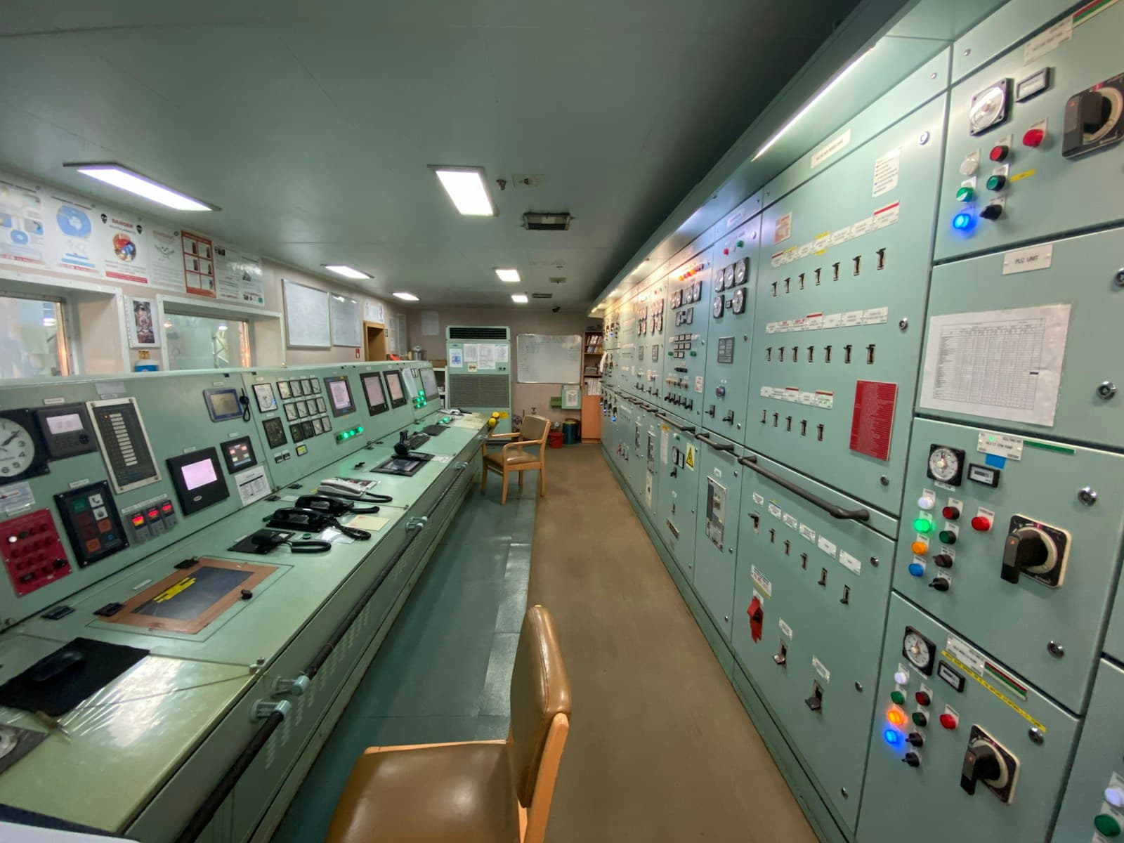 Electrical control room with wiring, equipment, and indicator panels aboard a vessel.