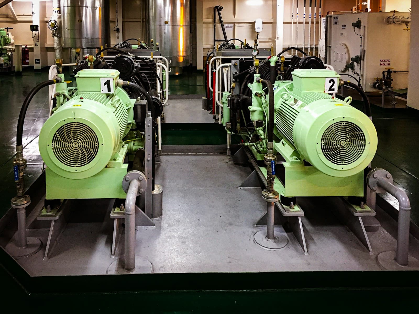 Engine room machinery and propulsion systems aboard a container vessel.